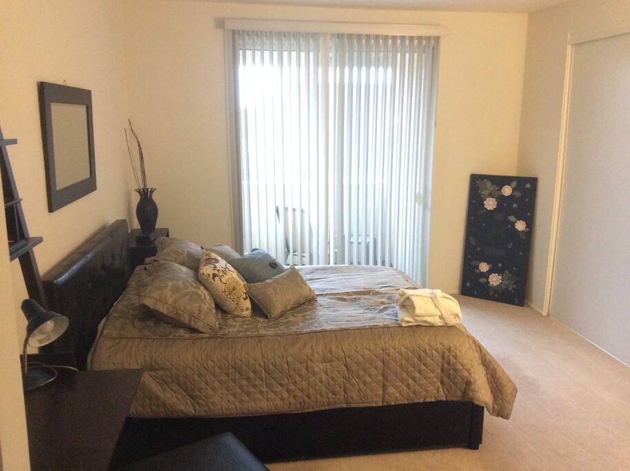 Master bedroom has a private patio with chair and table. Lots closet space to hang your more formal clothing items.