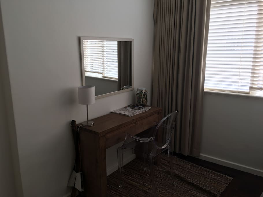 Bedroom with desk, lamp and large mirror