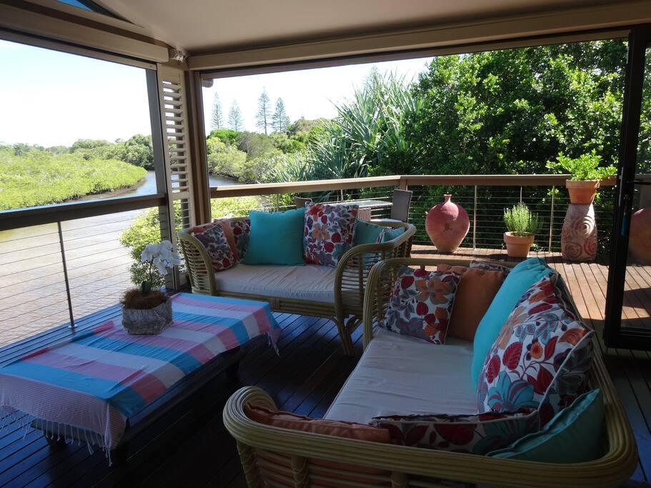 The spacious roofed verandah has electronic blinds on two sides to control weather and provide a perfect outdoor room.