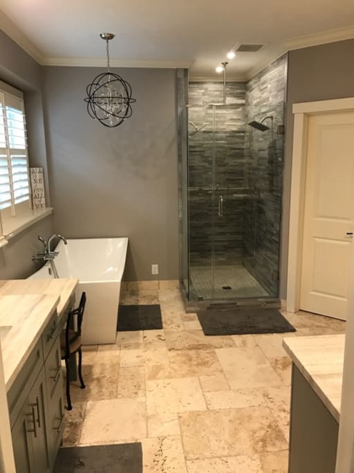 Master bathroom suite with double sinks, freestanding tub, 3 raining shower heads and a shower wand.