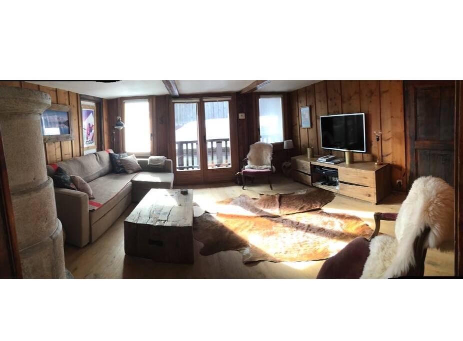 Panoramic view of the lounge, with double doors opening onto the South Facing balcony and fully connected entertainment