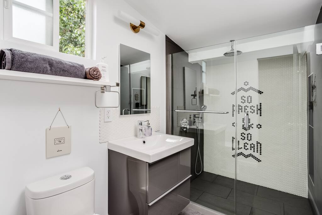 Spacious spa bathroom, shower of your dreams features rain shower head and handheld