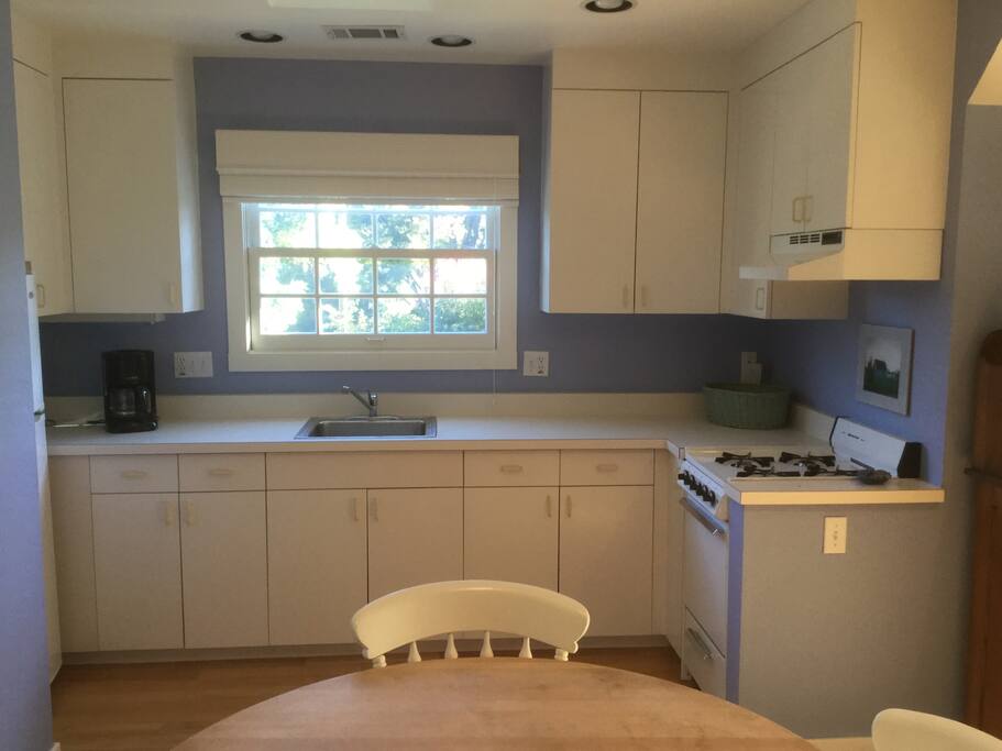 Kitchen with stove, refrigerator and microwave