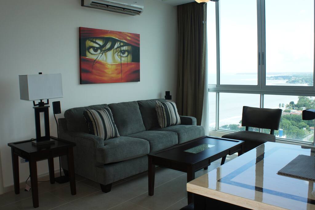 Living room with ocean & mountain views