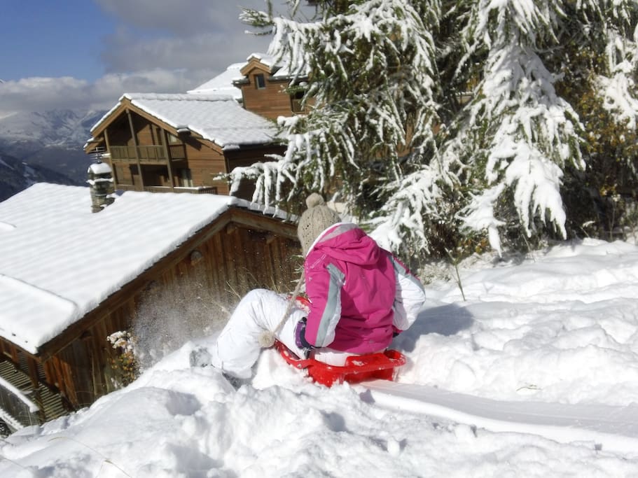 Sledging in the meadow behind chalet