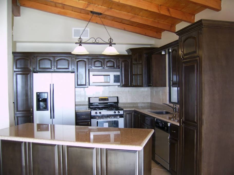 Full kitchen with stainless steel appliances.