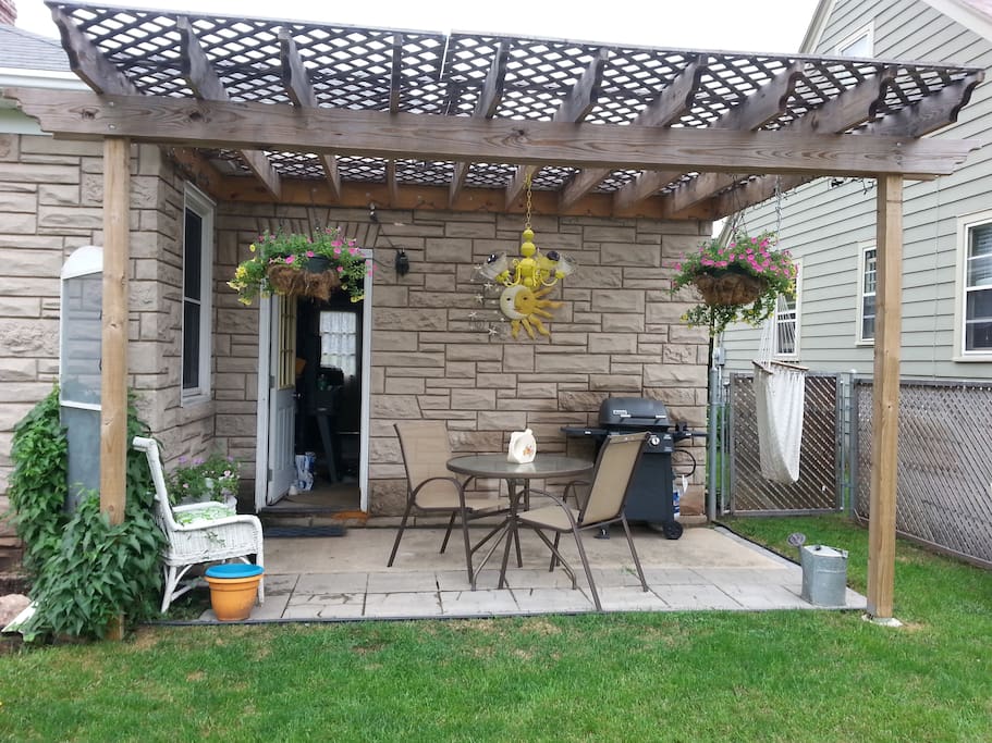 Outdoor patio with lighted pergola and gas grill to entertain.