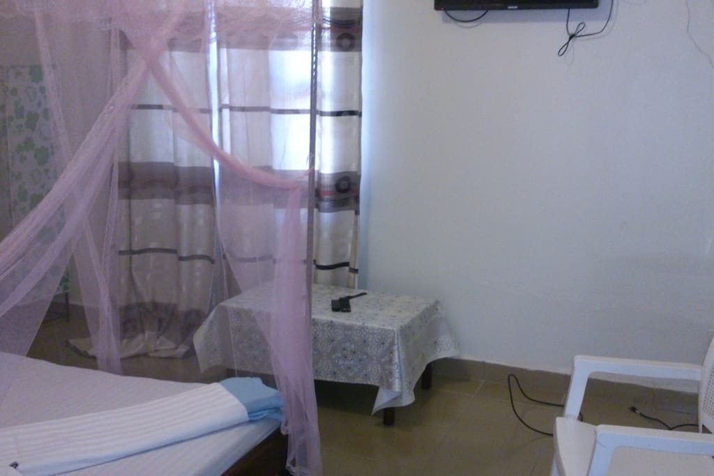 A pretty nice clean room for a guest with a bath room and satellite tv