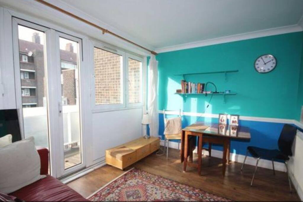 Front room with dining table and balcony