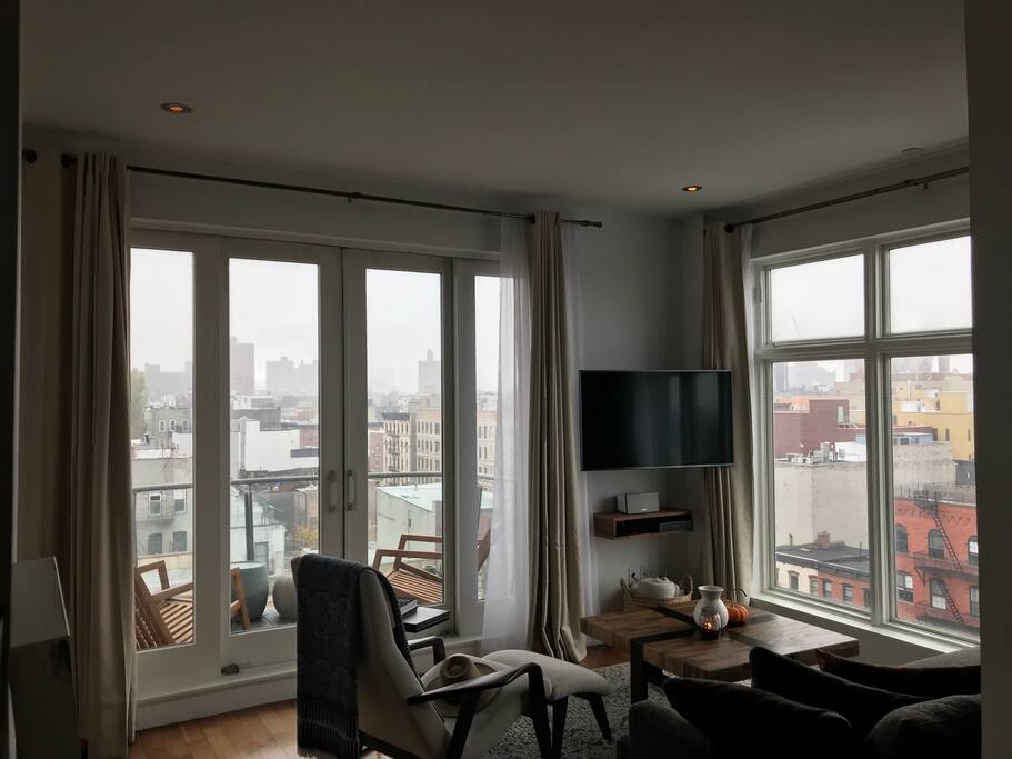 Living room - wall-to-wall, floor-to-ceiling windows on the west and south walls.