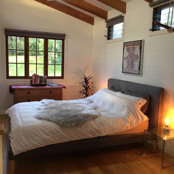 The bedroom has a new, comfy queen bed with designer linen, and a modern en suite bathroom