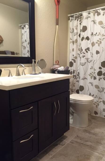 Recently remodeled bathroom with tub/shower, heated tile floors and marble countertops.