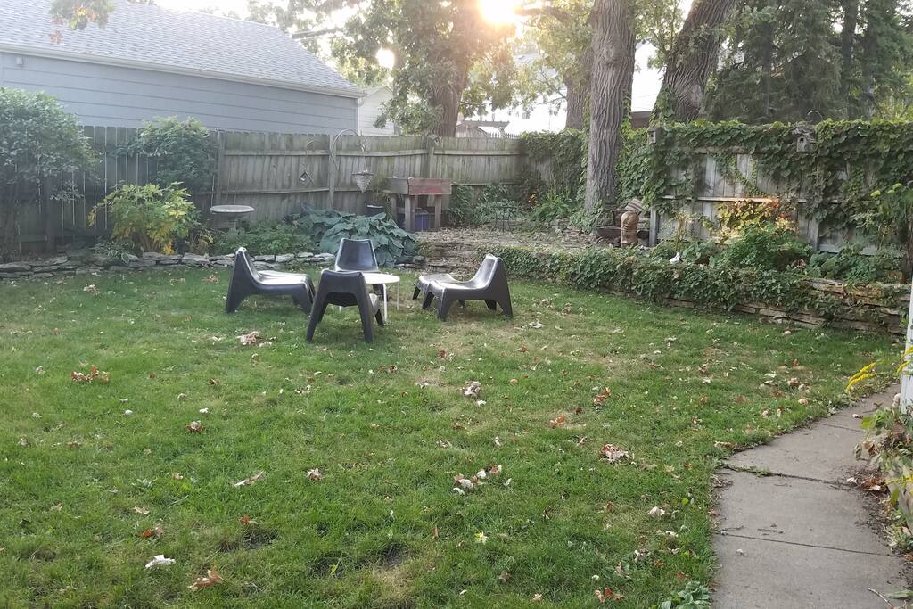 Spacious backyard with privacy fence and fire pit.