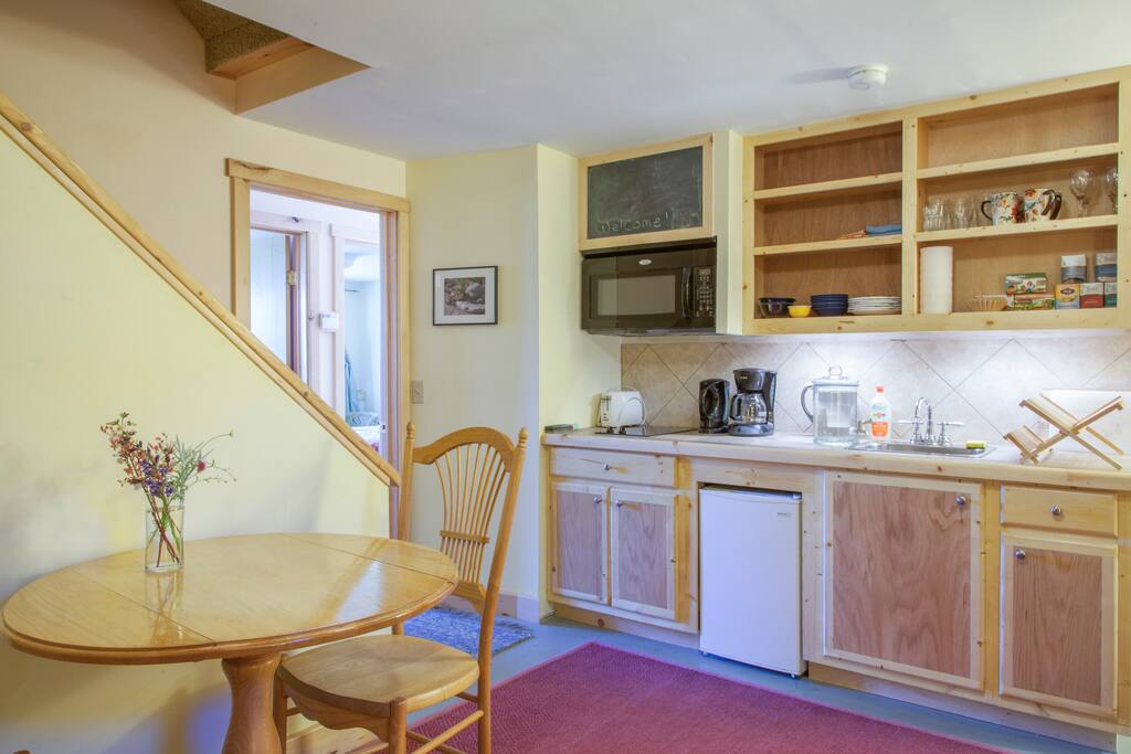 Dining, kitchen and living room! The mini-fridge is stocked with local, organic, and some homemade breakfast options including fruit, homemade jam, homemade yogurt, milk, juice, bagels, and coffee. Full kitchen is complete with mini fridge, microwave, toaster, double stove top, sink and coffee maker.