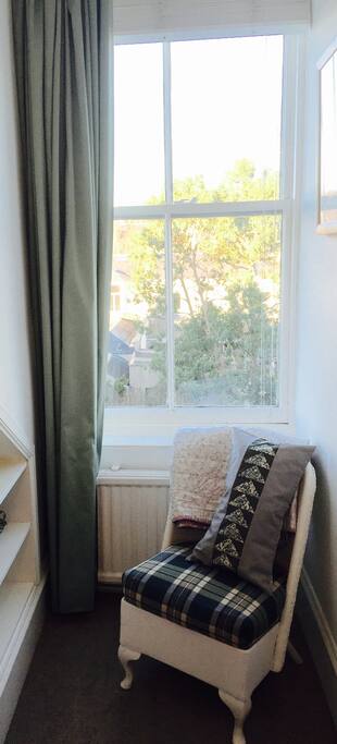 Bedroom window overlooks the garden and neighbouring rooftops.
