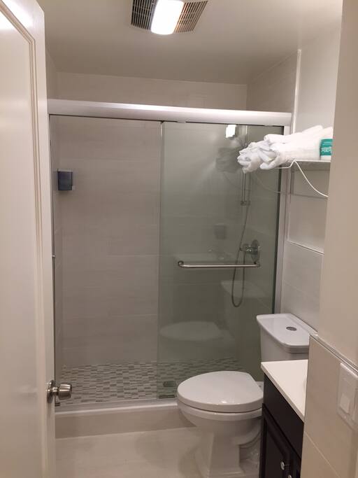 Private bathroom with shower and 2-in-1 conditioning shampoo & body wash provided