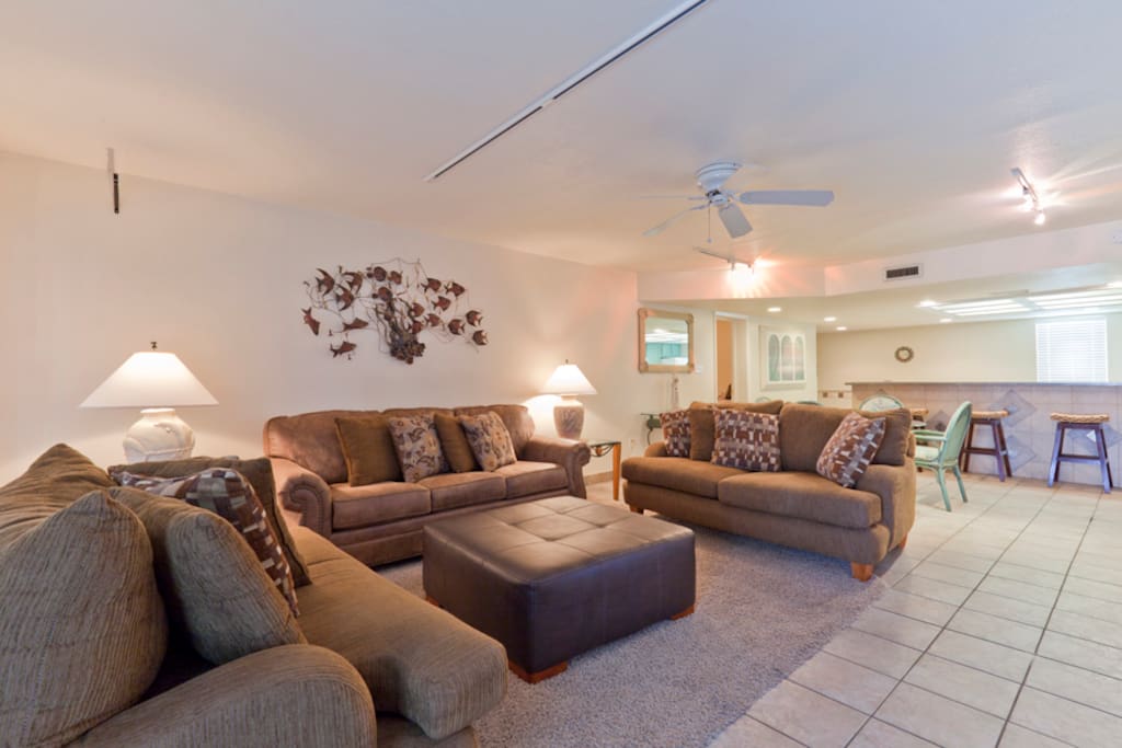 Living area with door that opens to beachfront balcony