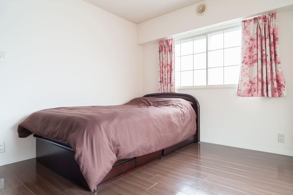 A double bed in the living/dining space