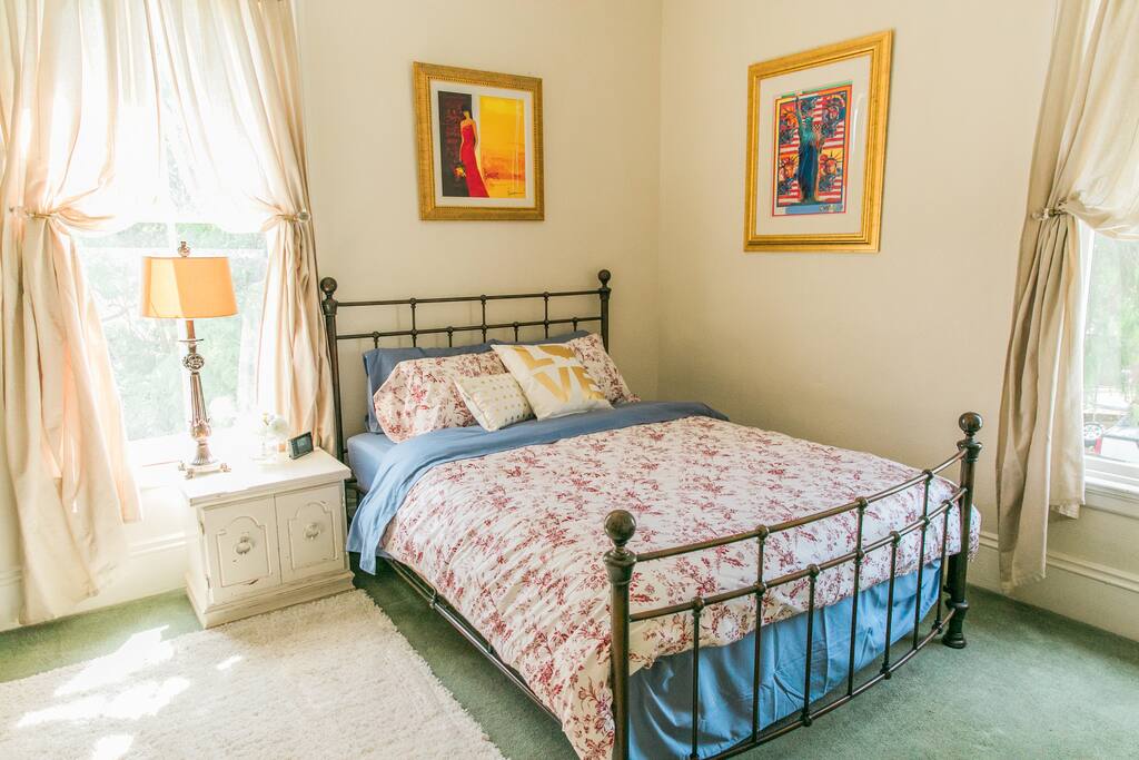 Queen size bed with a fluffy comforter.