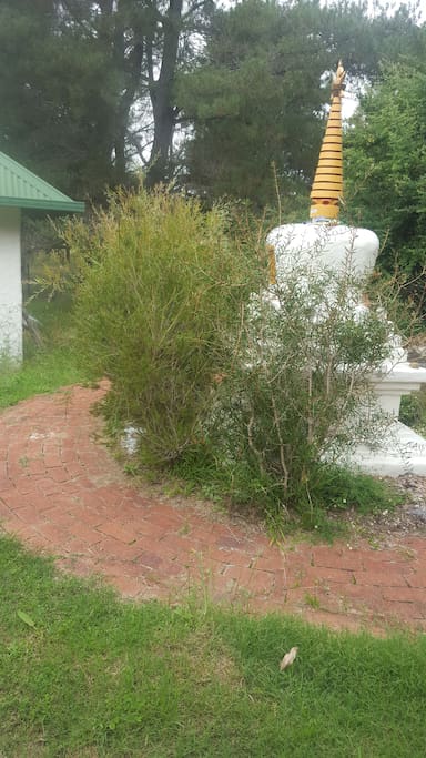Buddhist stupa on walkway to kitchen and bathroom entrance