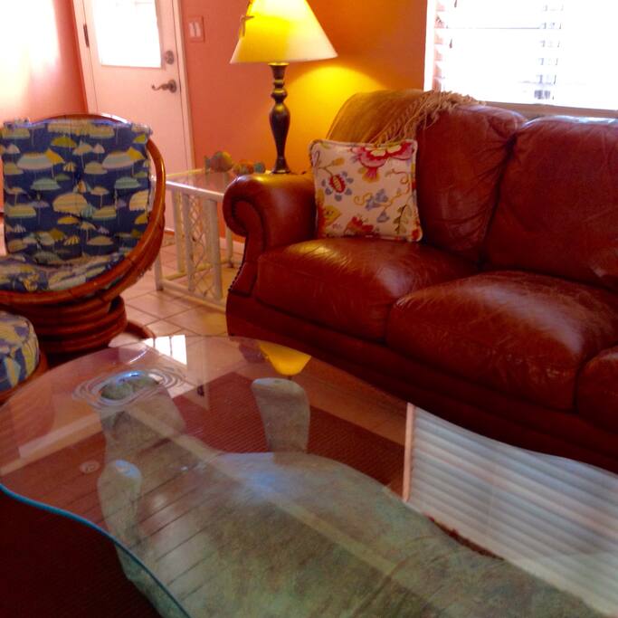 Living room with leather couch and Raton chair.