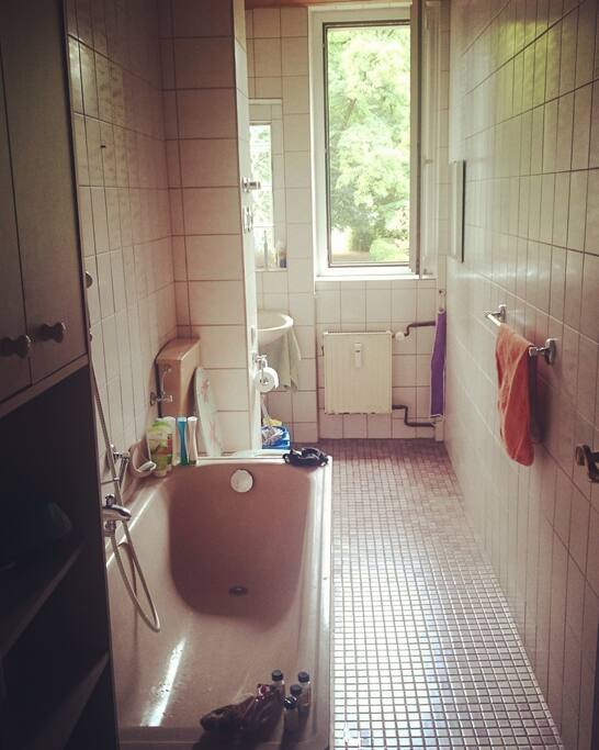 big bathroom with window and bathtub