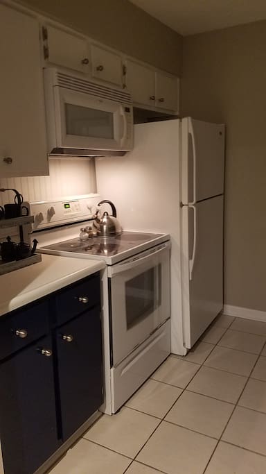 Full kitchen stocked with dishes and cookware.