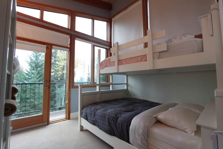 Third bedroom with single bunk beds and private balcony looking over the valley