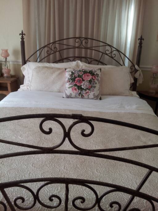 Queen bed with small desk for work or catching up with friends.