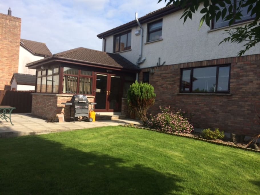 Rear Garden towards Large Sun Room Conservatory Patio areas.