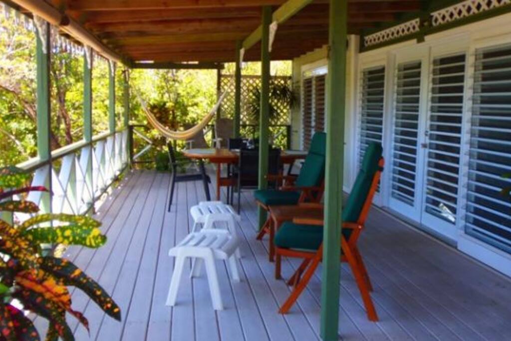 West facing porch with chairs, table that seats 6 and a hammock