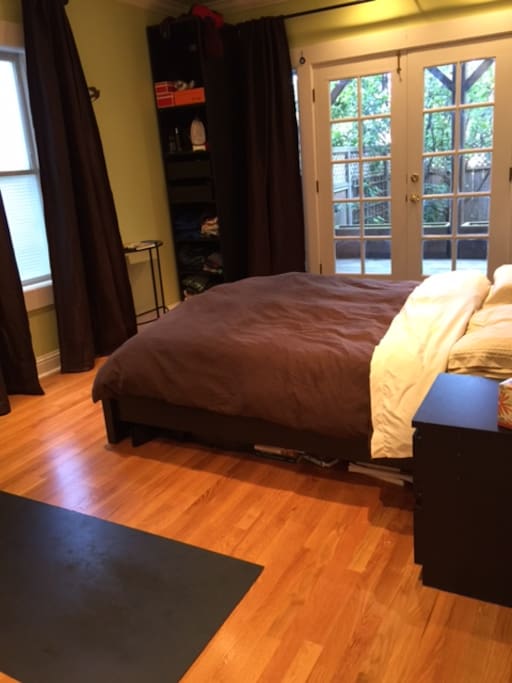 Master bedroom with ensuite bathroom and doors out to the back deck and the back yard. Queen-sized mattress.