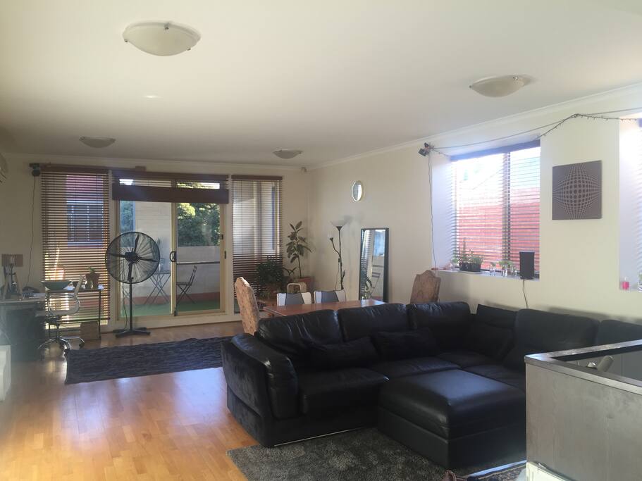 Huge lounge area with lots of plants and natural light