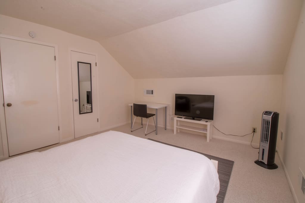 The bedroom also has a work desk/chair, TV and a large walk-in closet.