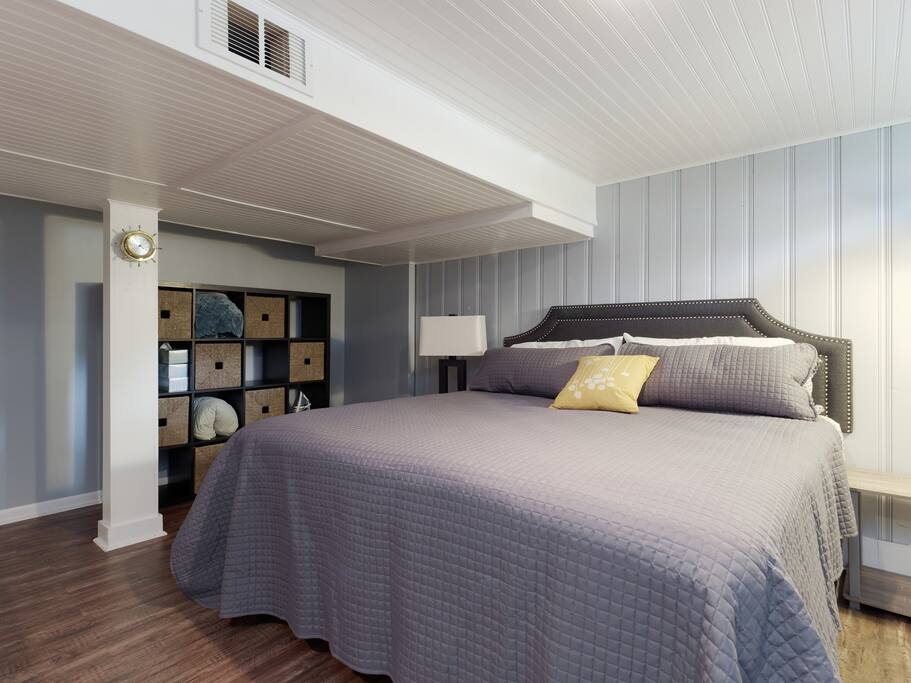 King size bed with lots of pillows.