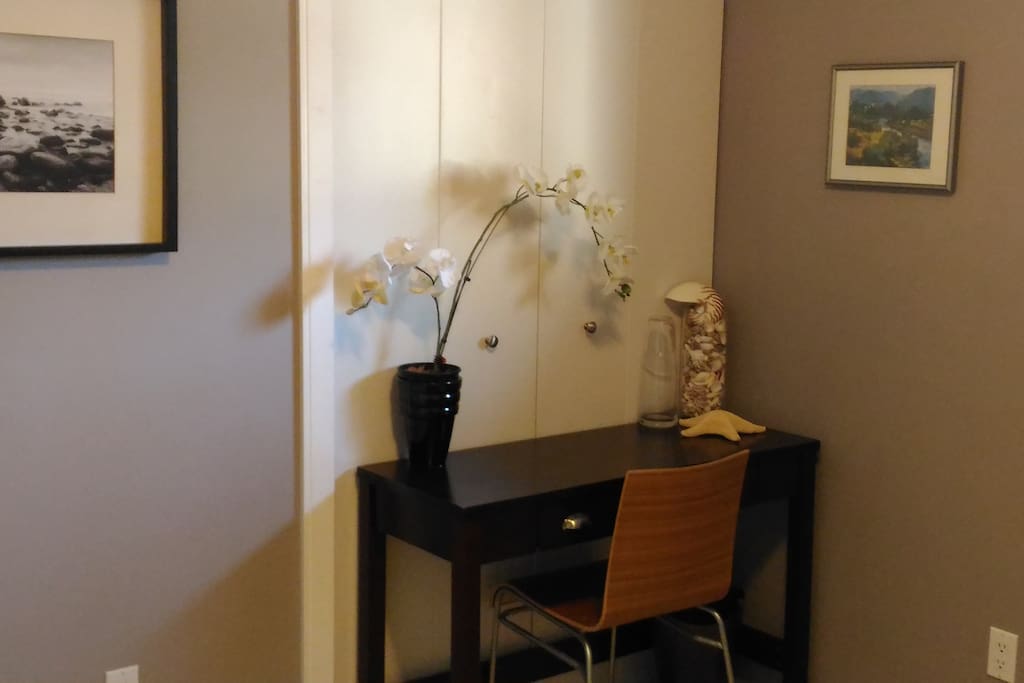 Writing desk and chair in room for your comfort , perfect for laptop.