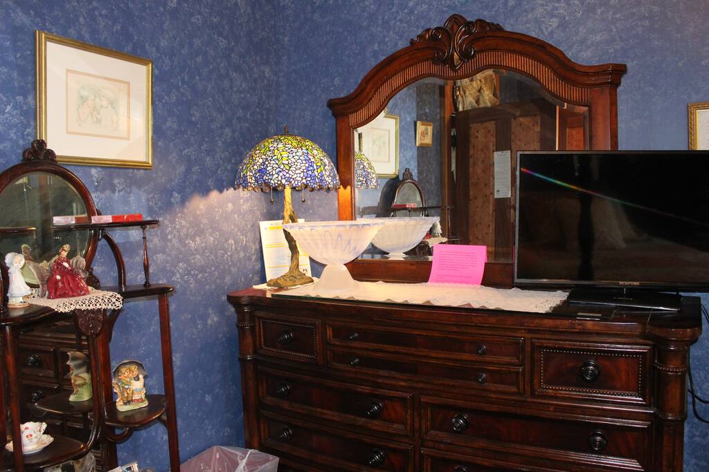 Antique dresser for your belongings plus a flat screen tv with a dvd player and a library of movies for your entertainment.