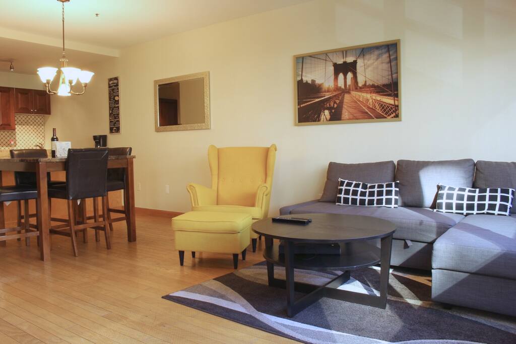 Beautiful, spacious living room, with areas for dining, relaxing, and watching TV.
