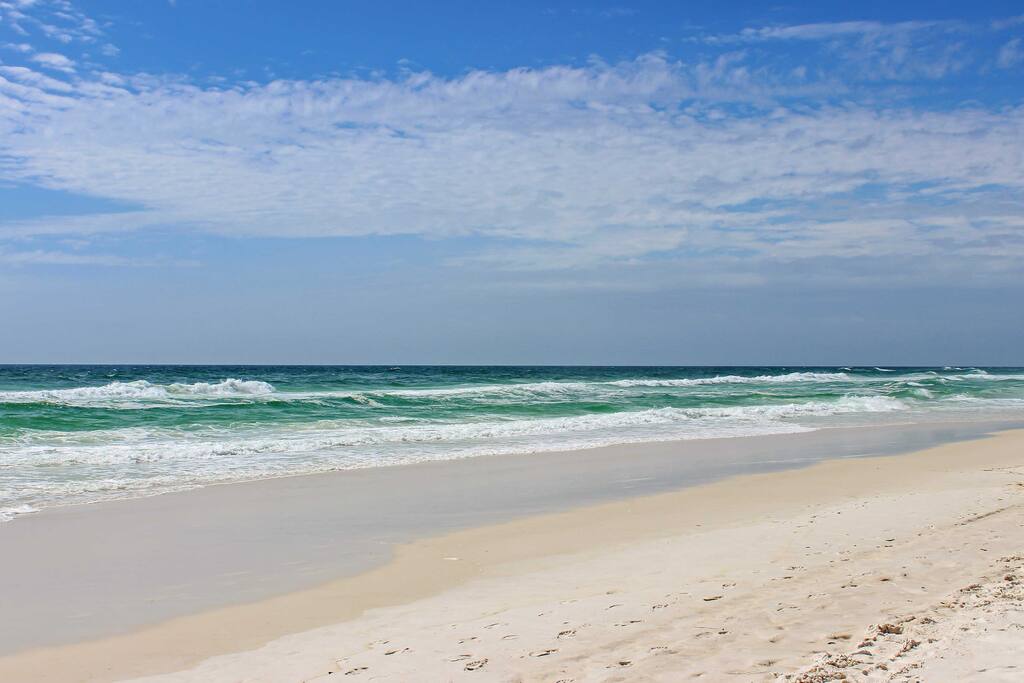 Steps from the beach, this home will provide you and your travel companions with endless fun in the sun.