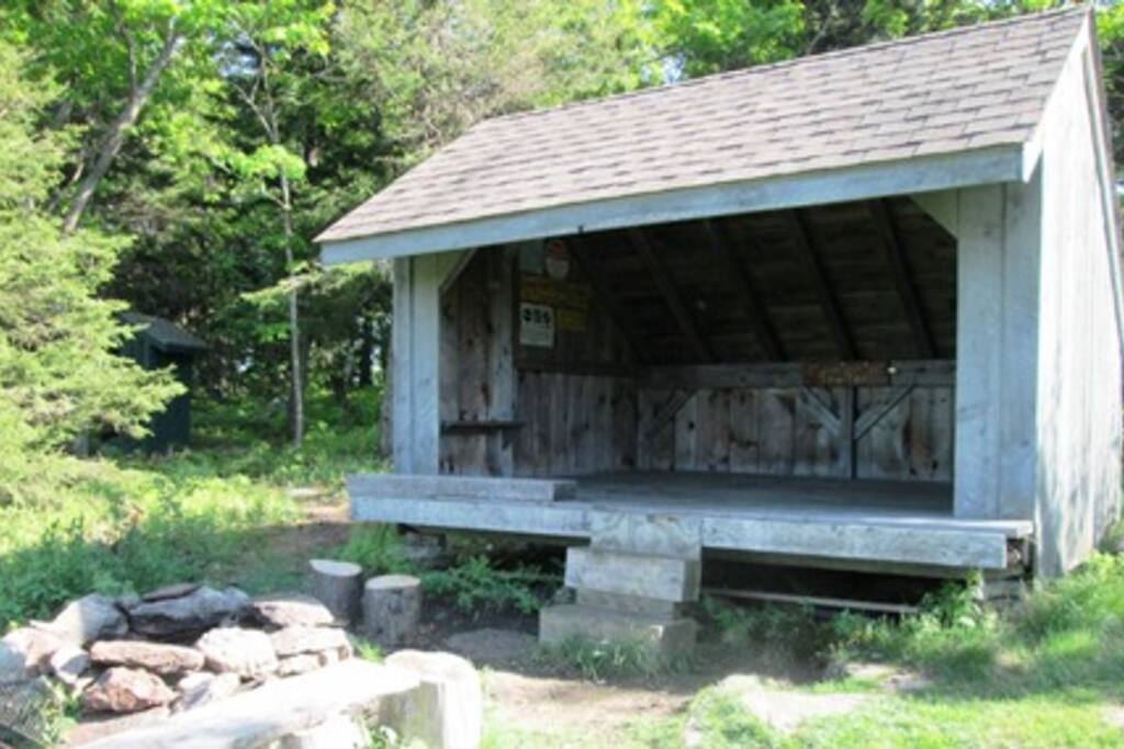 Mountain Top Shelter equip with campfire firepit and seating right in front.