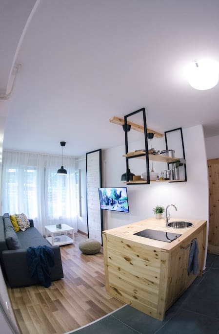 The living room offers a cosy sofa which can be converted into a comfortable bed for two, a kitchen with a bar and a widescreen TV.