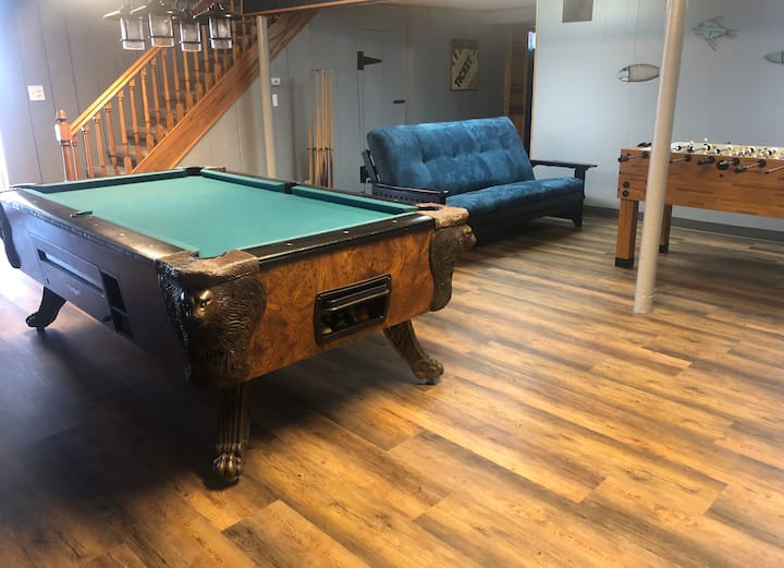 Downstairs game room with pool table, foosball table, full size futon, Wet Bar and 58" smart TV.