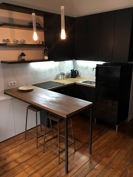 Kitchen is equipped with a large fridge with freezer, kettle and complete set of cookware.