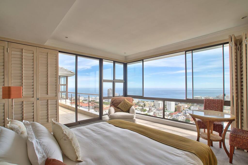 Main bedroom with floor to ceiling windows, bathroom en suite (bath and shower).