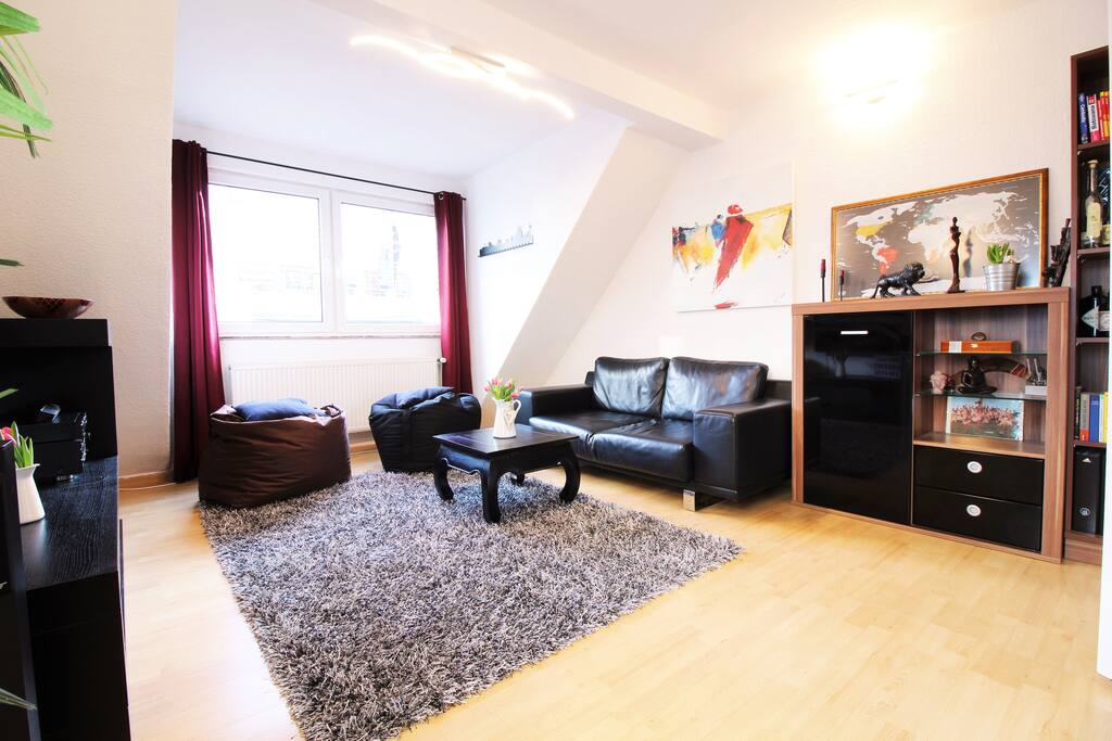 Bright and cozy living room with fluffy carpet, ideal for a quiet moment after a busy day in the city.