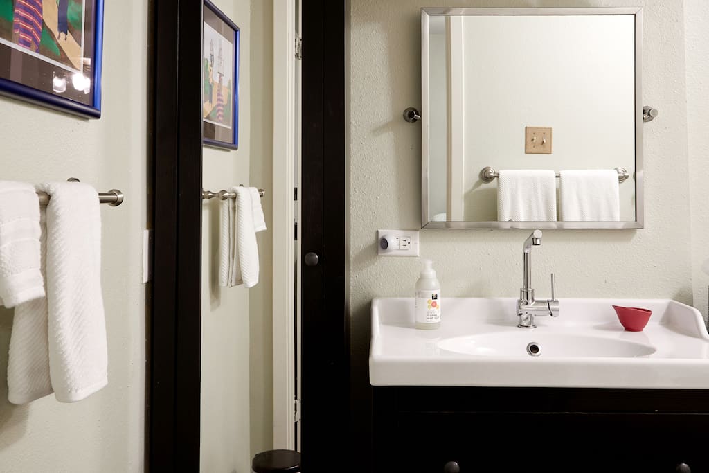 Large bathroom with all natural body wash, shampoo, conditioner, lotion. Assortment of toiletries and things you may have forgotten.