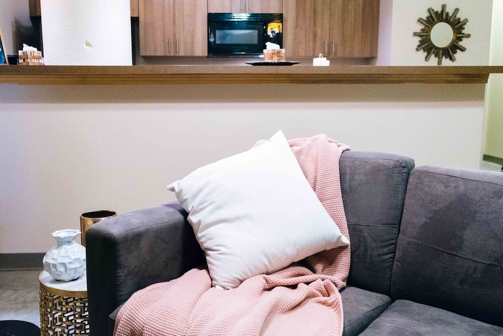 Soft suede L-couch. Extra blankets in basket.