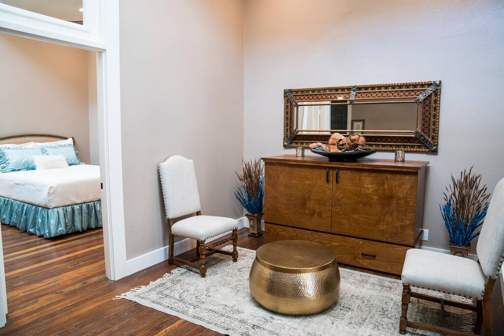 Entry/game room in apartment #1 with queen murphy bed, view into master bedroom