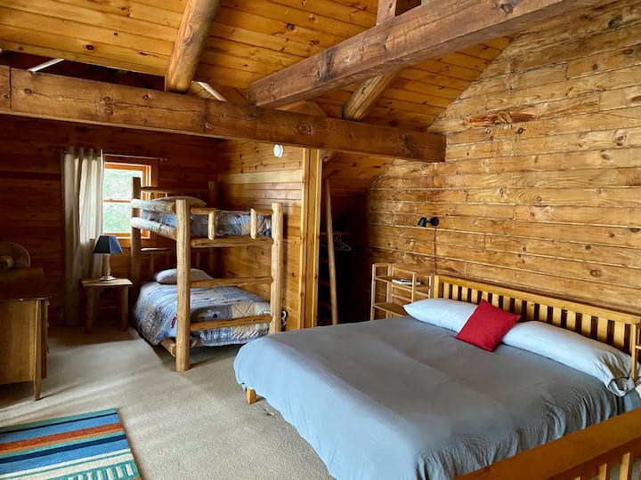 Upstairs loft view of our king bed and twin bunks. Small closet space is available for hanging as well as a large dresser. To the right you see the stairs down. This photo is taken from the door of the upstairs bathroom.