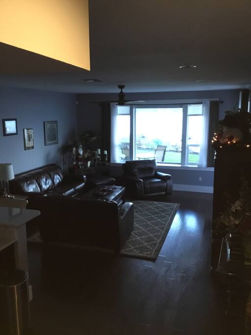 Guest living room with Large TV and open to guest kitchen.